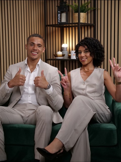 Two guests recording on the green sofa